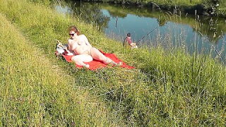 Nudist Beach. Public Nudity. Sexy Milf Without Panties And Bra Sunbathes Naked Is Not Shy About Fisherman. Naked In Public. Milf 